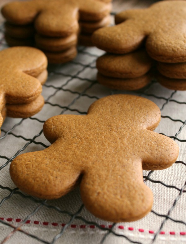 stacks of unfrosted gingerbread cookies laying out on a cooling rack